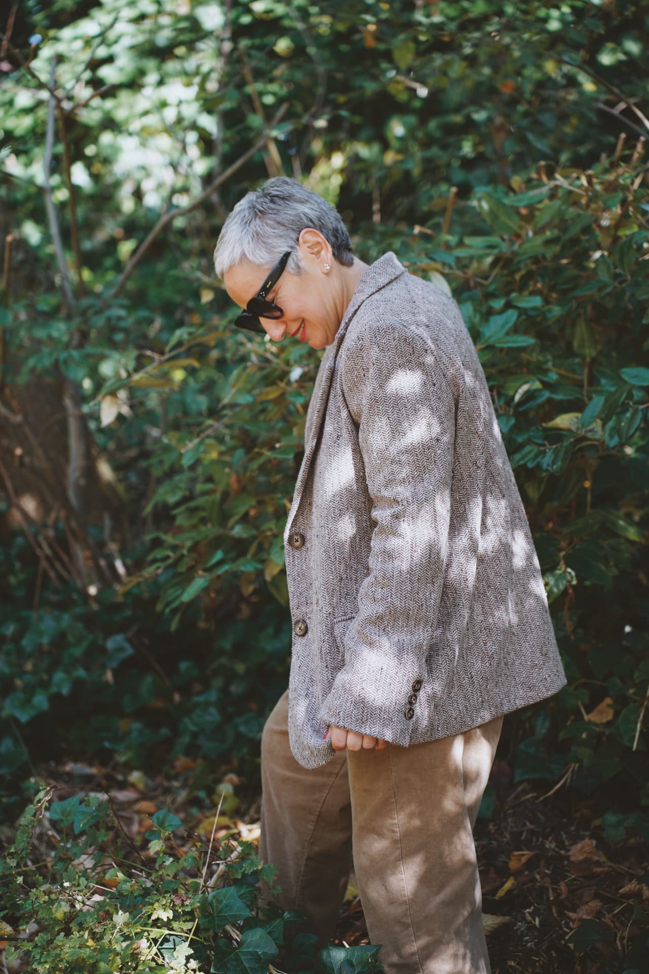 De profil dans la végétation, blazer en tweed et pantalon velours
